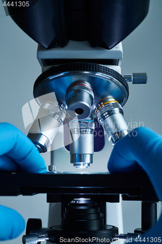 Image of Scientist hands with microscope