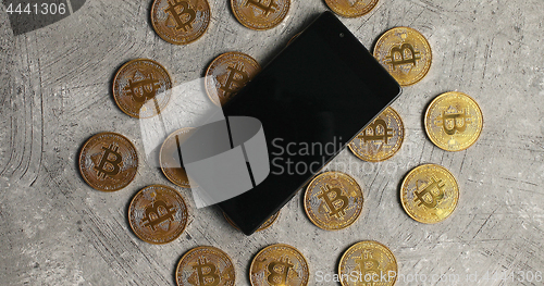 Image of Smartphone and bticoin on gray background