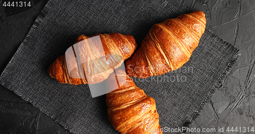 Image of Golden baked croissants on napkin