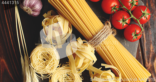 Image of Various pasta and tomatoes with garlic