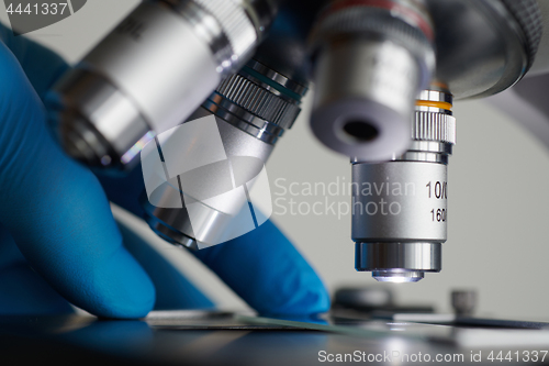 Image of Scientist hands with microscope