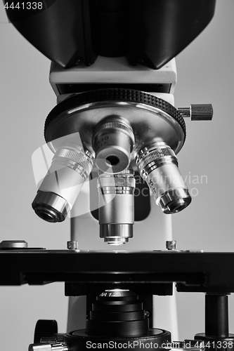 Image of Modern microscope with metal lens at laboratory.