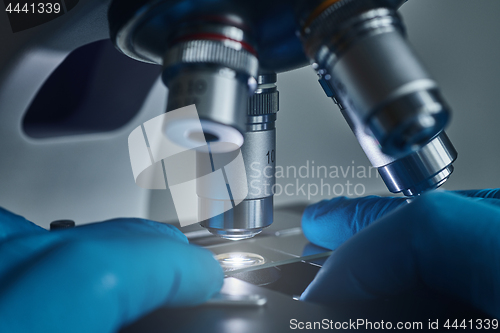 Image of Scientist hands with microscope