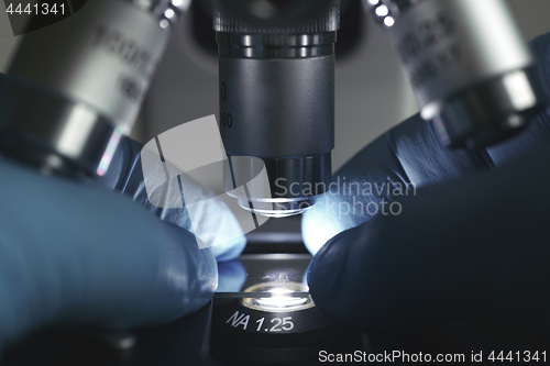 Image of Scientist hands with microscope