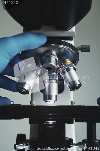 Image of Scientist hands with microscope