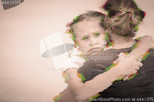 Image of Portrait of a sad daughter hugging his mother.