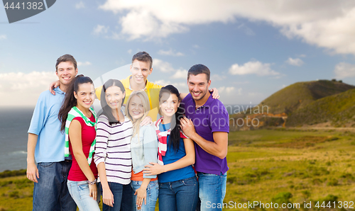 Image of group of happy friends over big sur coast