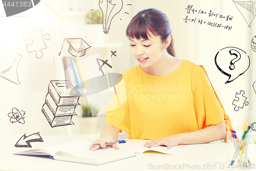 Image of happy asian young woman student learning at home