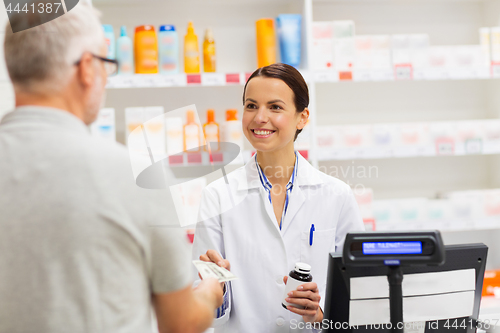 Image of apothecary selling drug to senior man at pharmacy