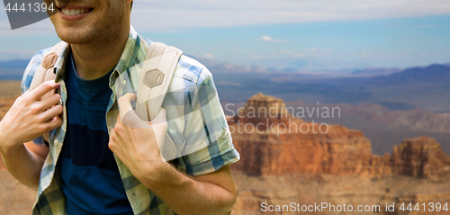 Image of close up of man with backpack over grand canyon