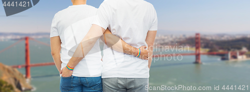 Image of male couple with gay pride rainbow wristbands