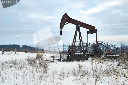 Image of Oil well on a winter landscape