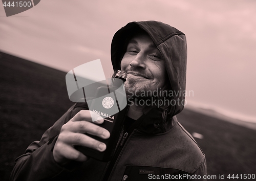 Image of Hooded man drinking in Iceland