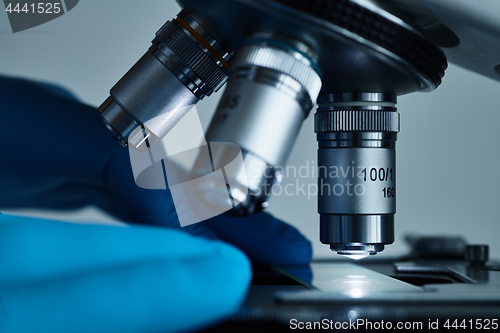 Image of Scientist hands with microscope