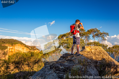 Image of Looking out across the mountains from a rocky cliff