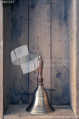 Image of the bell of Santa Claus with wooden background