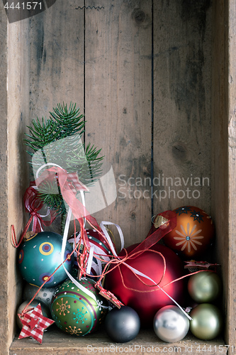 Image of Christmas decoration glass balls in a wooden box background