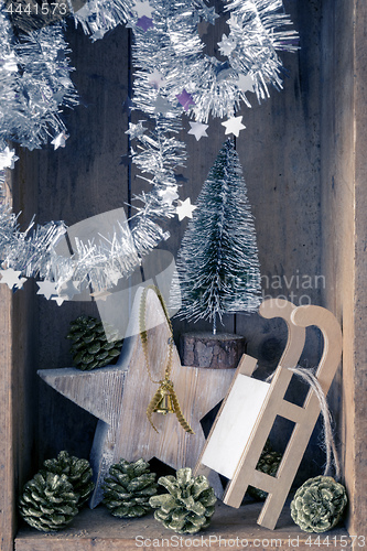 Image of Christmas decoration golden bell jar, sledge, star and tree in a