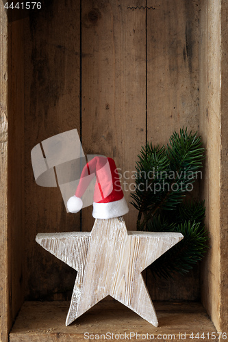 Image of Christmas decoration Santa Clause hat on a star in a wooden box 