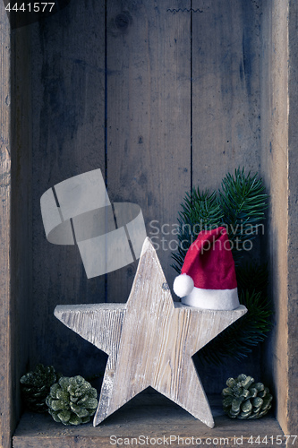 Image of Christmas decoration Santa Clause hat on a star in a wooden box 
