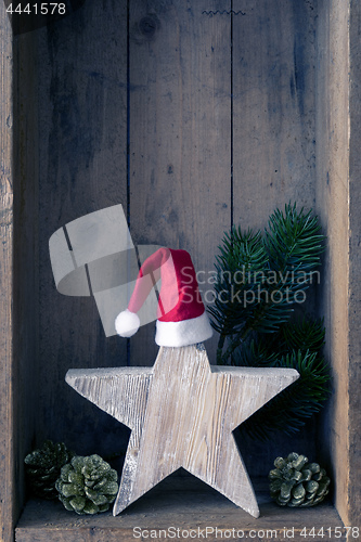 Image of Christmas decoration Santa Clause hat on a star in a wooden box 