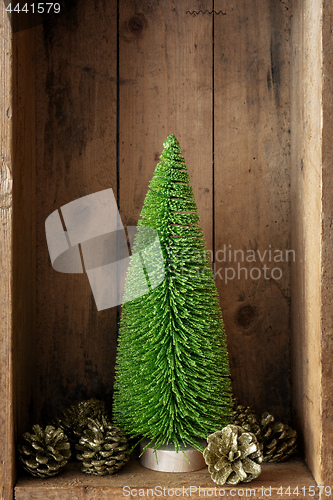 Image of Christmas decoration pinecone and tree in a wooden box backgroun