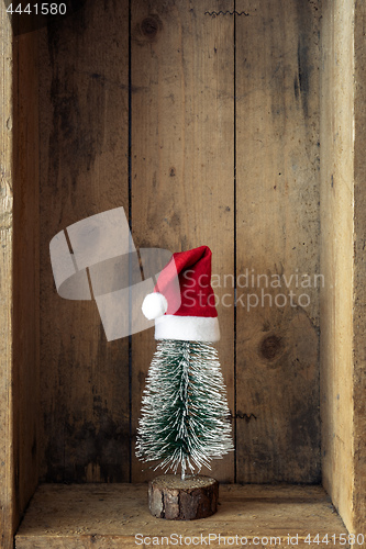 Image of Christmas decoration Santa Claus hat and tree in a wooden box ba