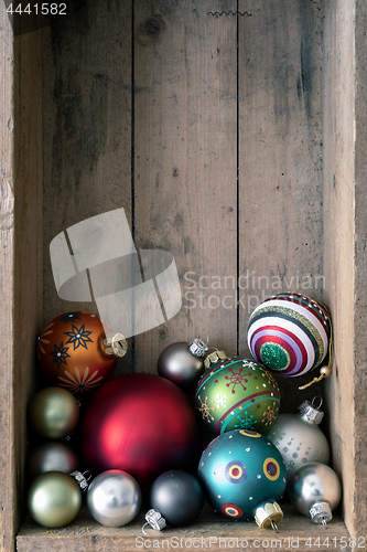 Image of Christmas decoration glass balls in a wooden box background