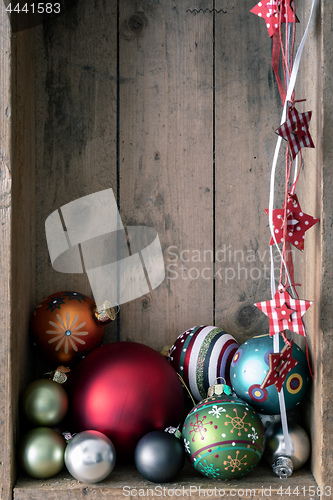 Image of Christmas decoration glass balls in a wooden box background