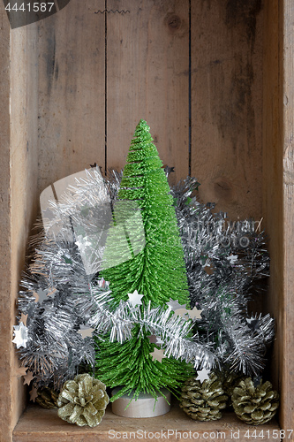 Image of Christmas decoration pinecone and tree in a wooden box backgroun