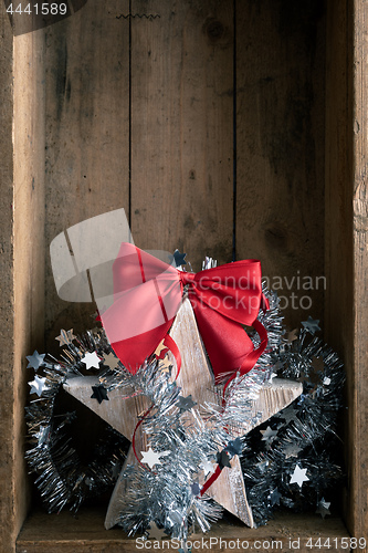 Image of Christmas decoration wooden star in a wooden box background