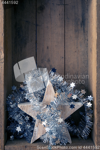 Image of Christmas decoration wooden star in a wooden box background