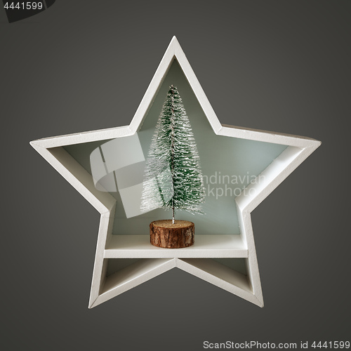 Image of Christmas decoration white star with fir tree inside