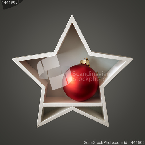 Image of Christmas decoration white star with red glass ball inside