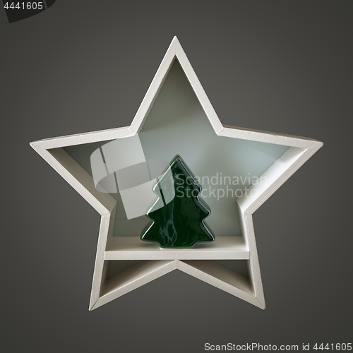 Image of Christmas decoration white star with tree figure inside