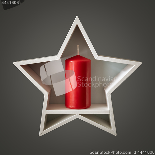 Image of Christmas decoration white star with red candle inside