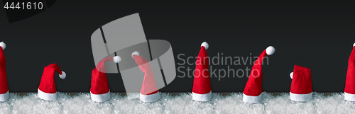 Image of seamless row of red Santa Claus hats