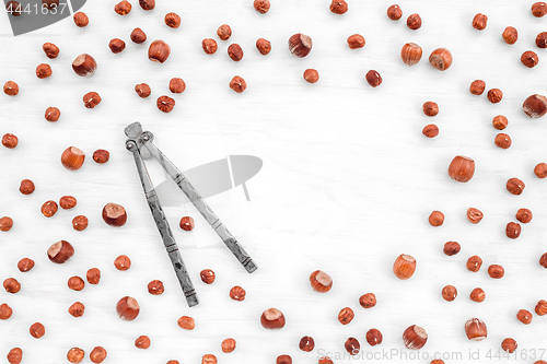 Image of Nutcracker and hazelnuts on white background with copy space