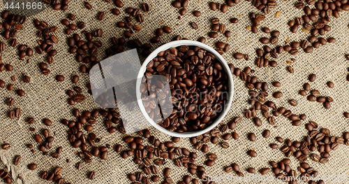 Image of Bowl of coffee beans on canvas