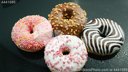 Image of Delicious glazed doughnuts on glass