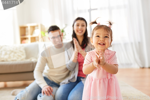 Image of happy baby girl and parents at home