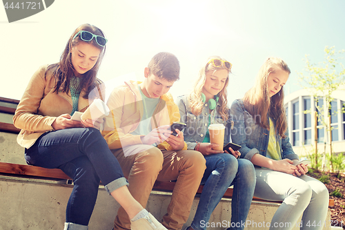 Image of teenage friends with smartphone and coffee cups