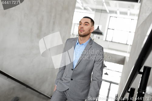 Image of businessman walking upstairs