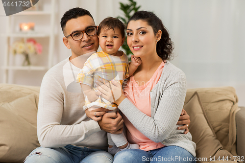 Image of happy family with baby daughter at home