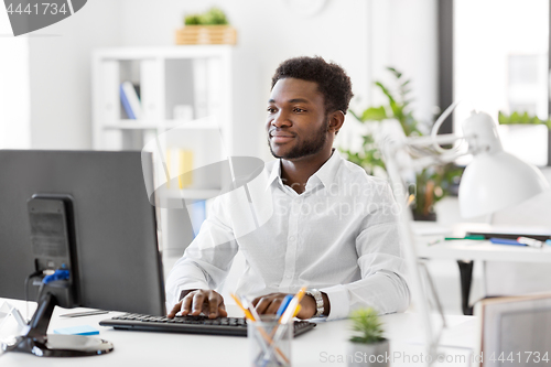 Image of african businessman with computer at office