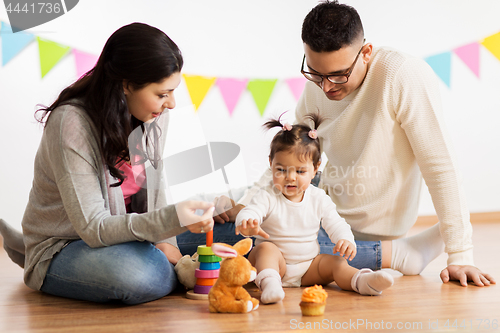 Image of baby girl with parents playing with toys