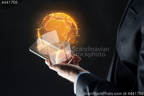 Image of hand with smartphone and earth hologram