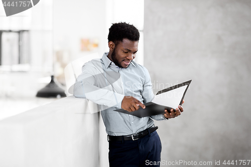 Image of african american businessman with folder at office