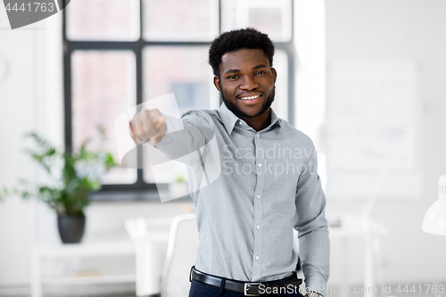 Image of african businessman at office pointing at you