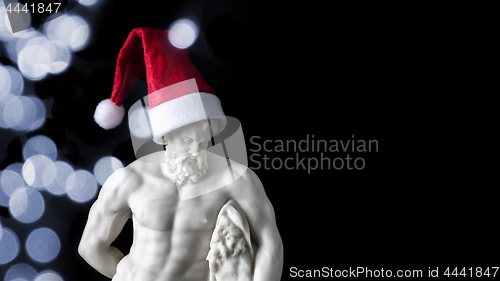 Image of muscular male figure with a Santa Claus hat
